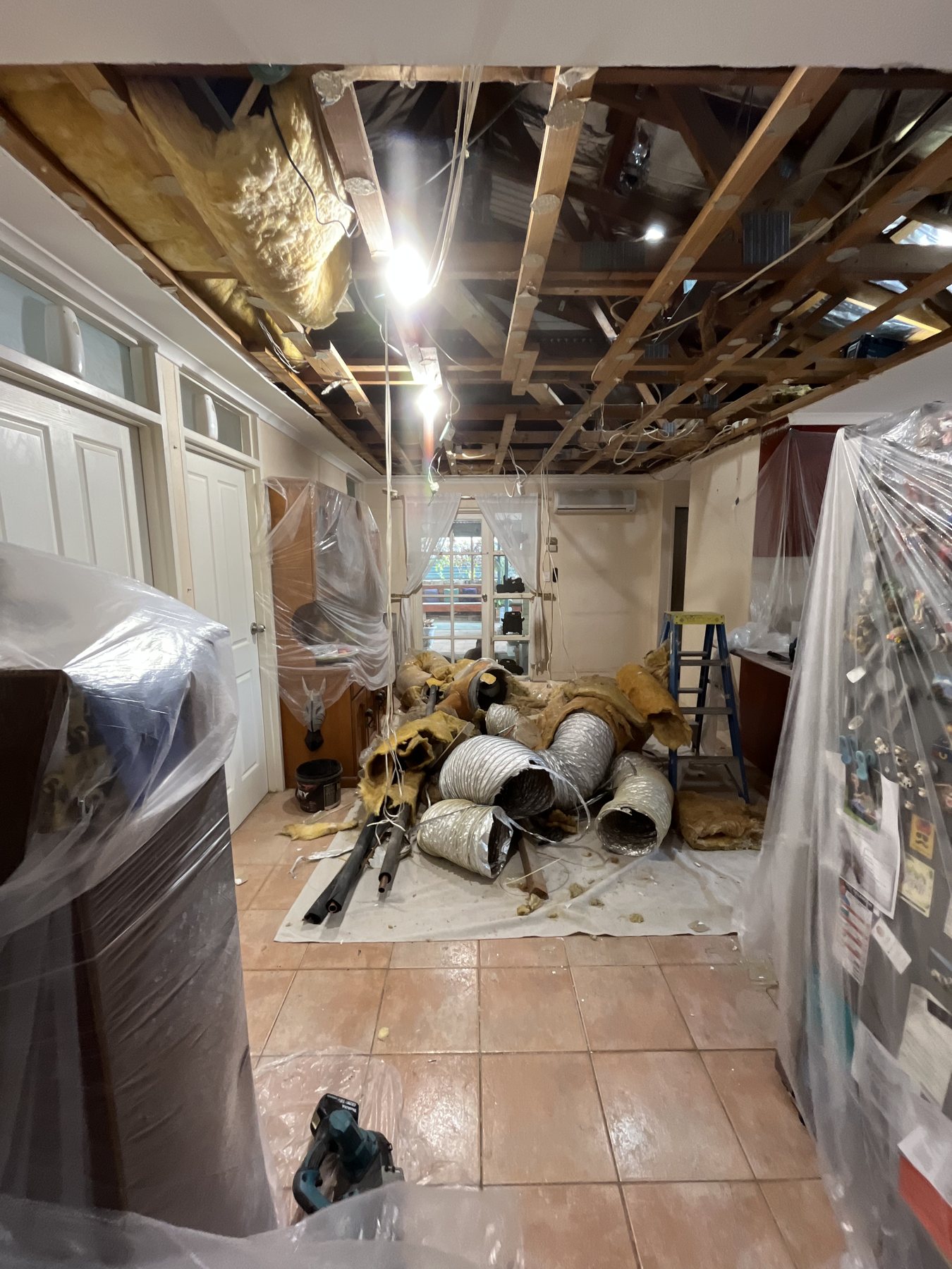 Furniture protected, room cleared to work.
